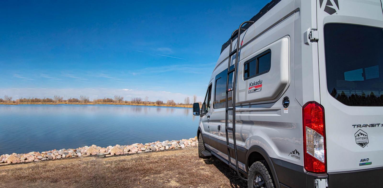 An Antero Adventure Van facing a lake in the background