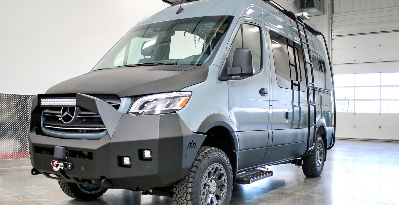 A Bamaga Antero Adventure Van inside a white garage