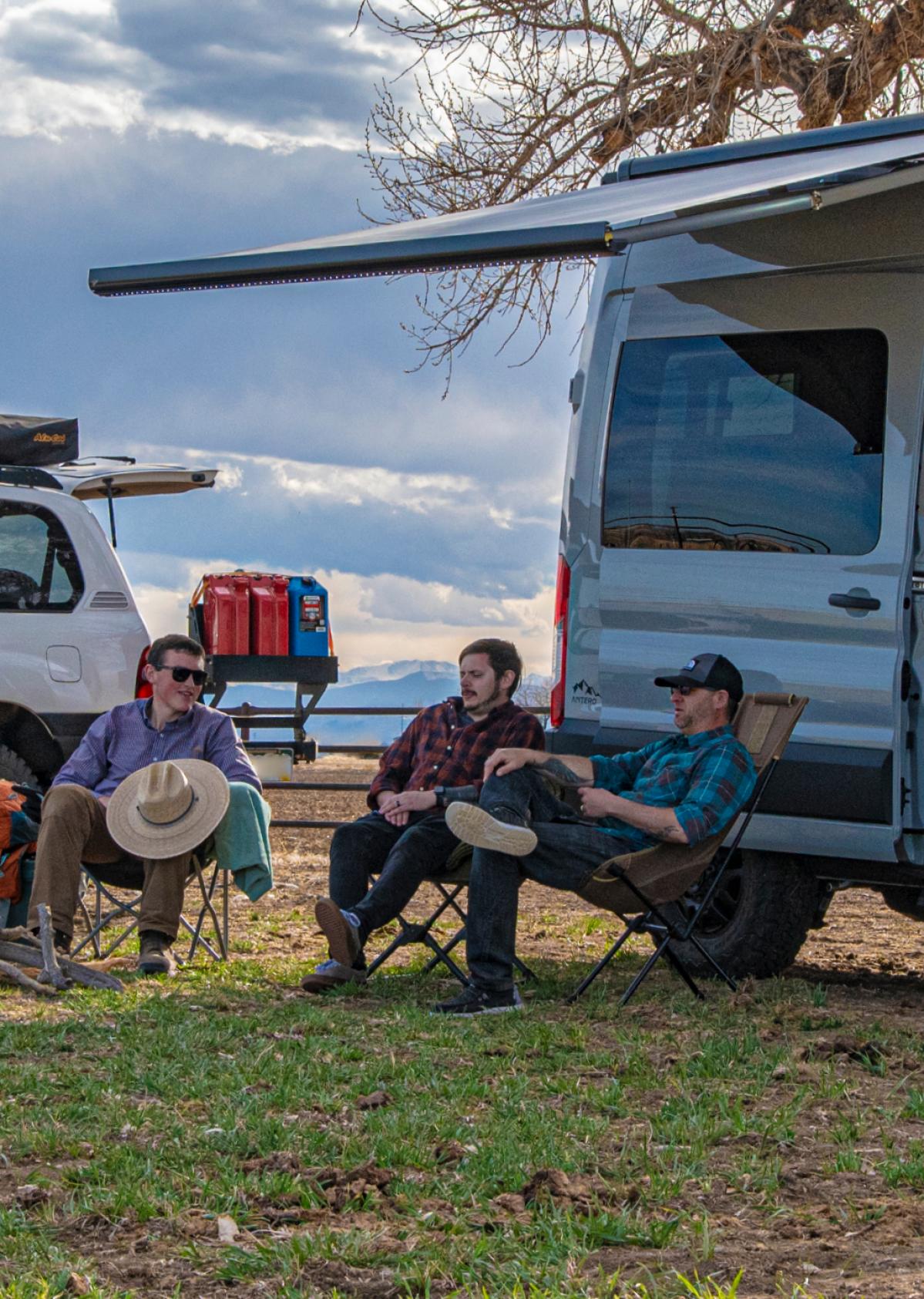 A group of friends hanging out in front of a Kakadu Antero Adventure Van