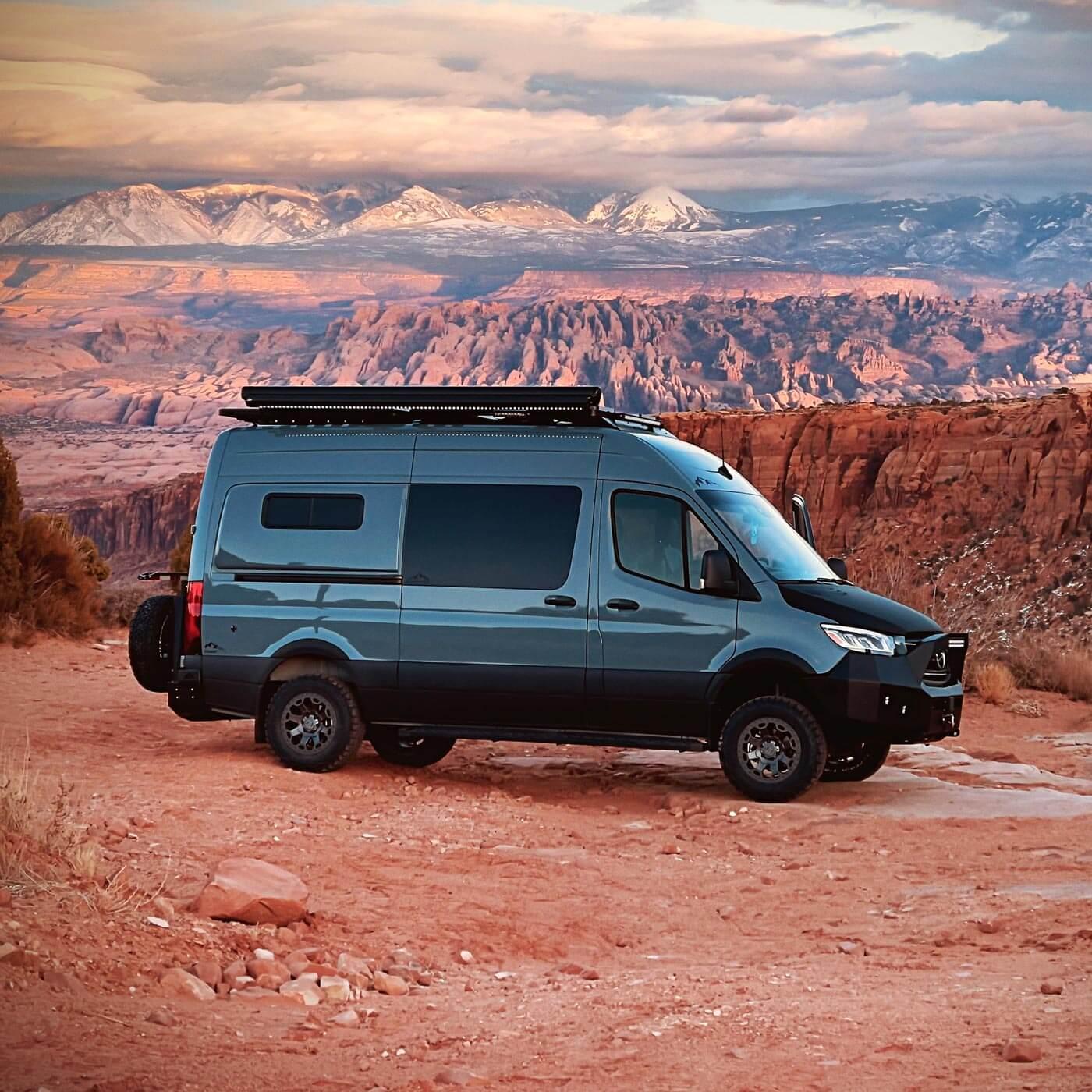 A Longs Peak Antero Adventure Van parked in front of a red rock canyon