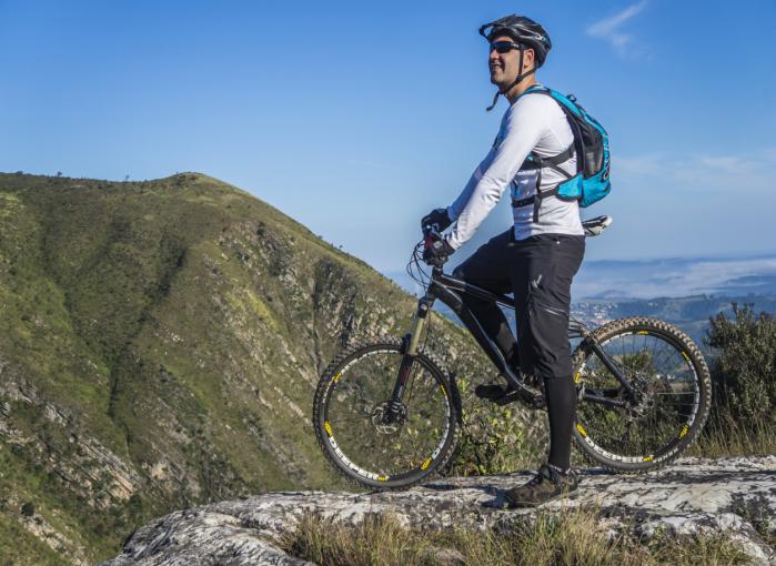 A mountain biker with a mountain in the background