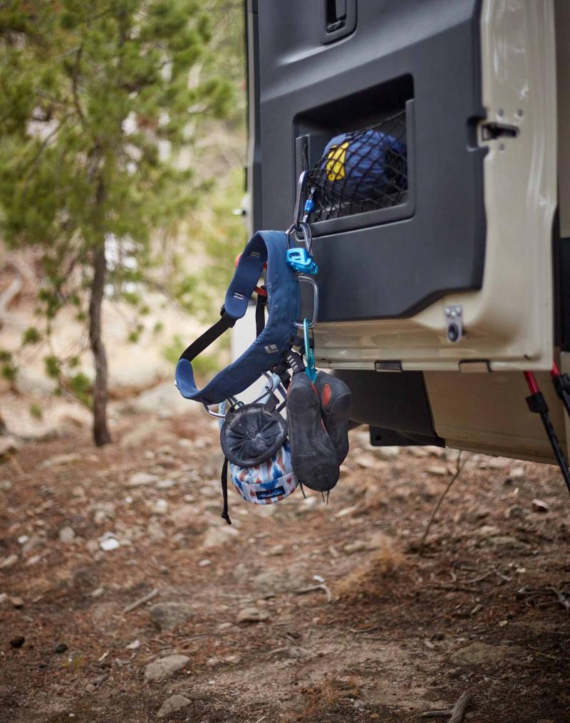 A climbing harness hanging from the back of an Antero Adventure Van