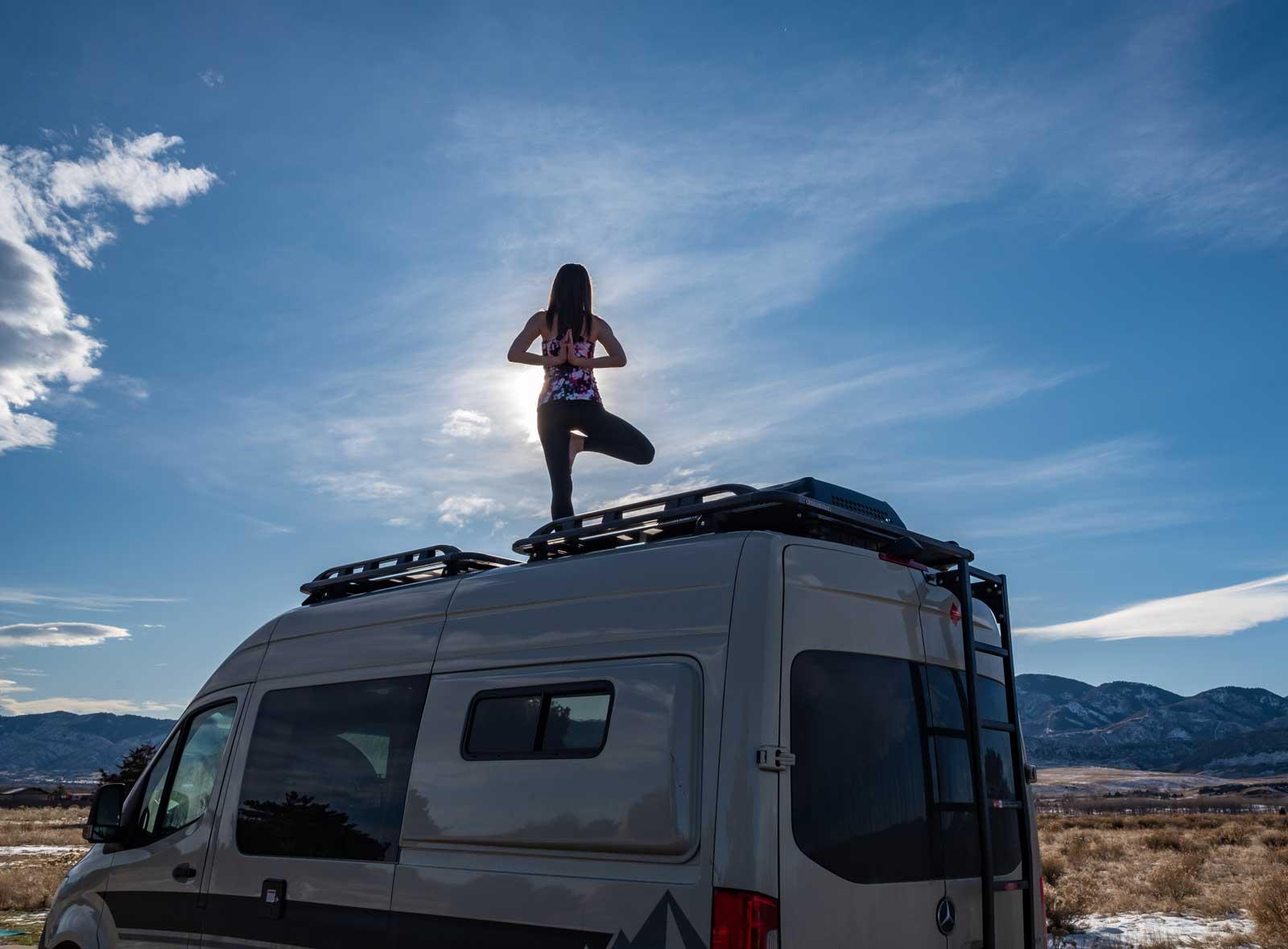 A person doing yoga on top of an Antero Adventure Van
