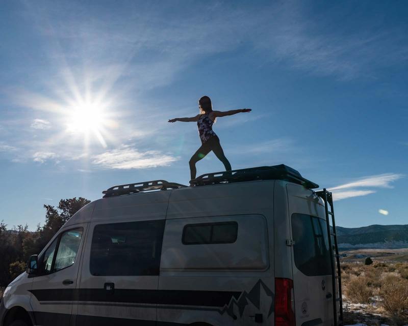 A person doing yoga on top of an Antero Adventure Van