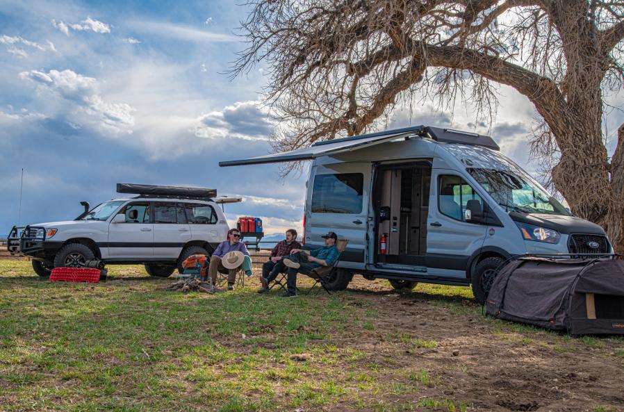 A group of friends hanging out in front of an Antero Adventure Van